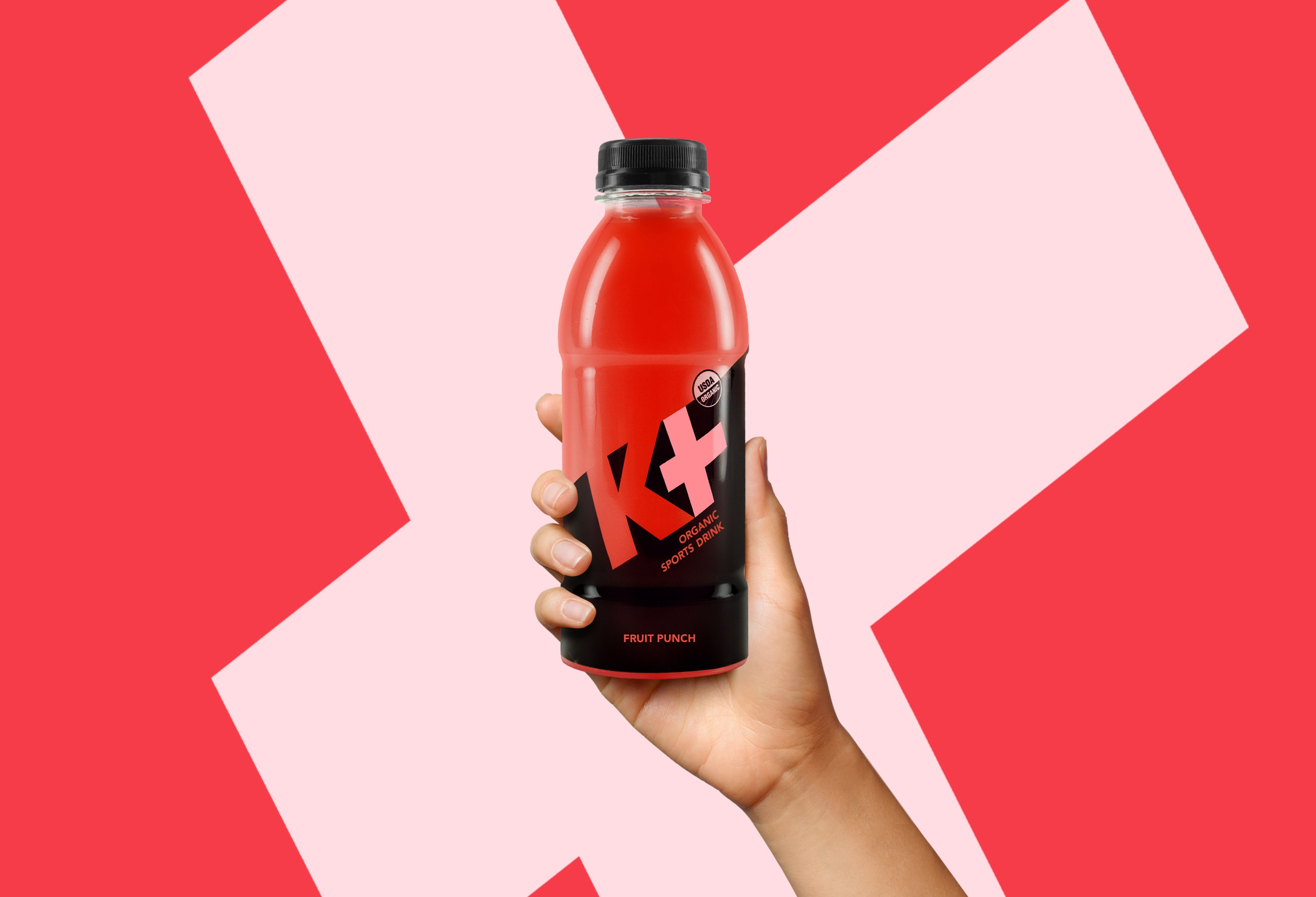 K+ hand holding bottle